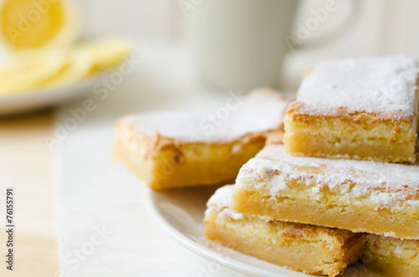 Fototapeta lemon bars on a white plate with slices