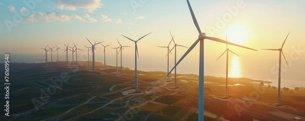 Fototapeta Wind turbines on a hilly landscape with a clear sky, harnessing wind energy in a natural setting. The beautiful harmony between technological advancement and natural landscape preservation.