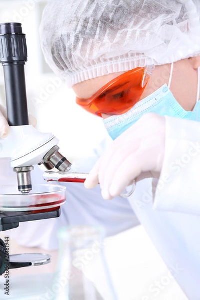 Obraz Male scientist using microscope in laboratory