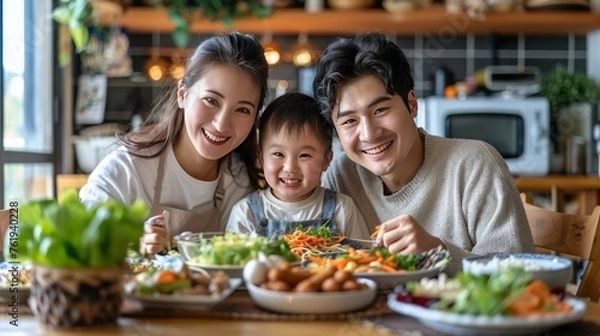 Fototapeta Man, Woman, and Child Sitting at Table