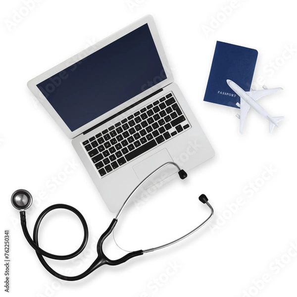 Fototapeta Top view of passport with airplane, computer and a stethoscope isolated on white background, medical insurance travel concept whether it's a summer beach vacation or a business trip. Health and safety