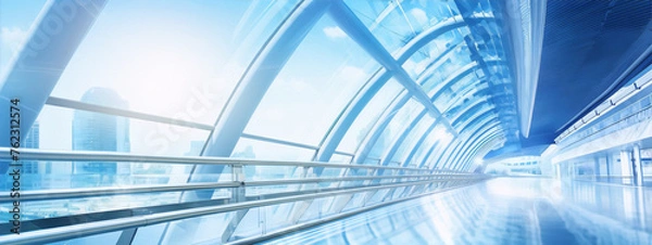 Obraz Futuristic glass tunnel with blue light reflections and a bright cityscape in the distance.