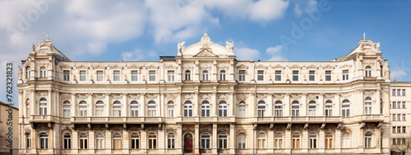 Obraz An old, white, three-story apartment building with lots of windows and ornate details on the facade.