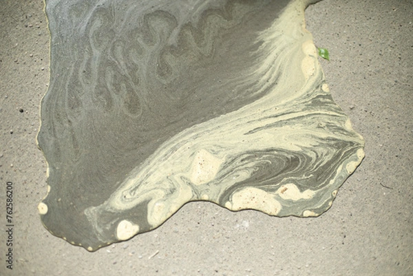 Obraz Water on asphalt. Pollen from plants in water. Puddle in road.