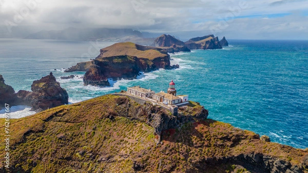 Fototapeta Lighthouse at Sao Lourenco peninsula on Madeira from an aerial view.
Drone photos of Farol da Ponta de São Lourenço with ocean waves and clouds.