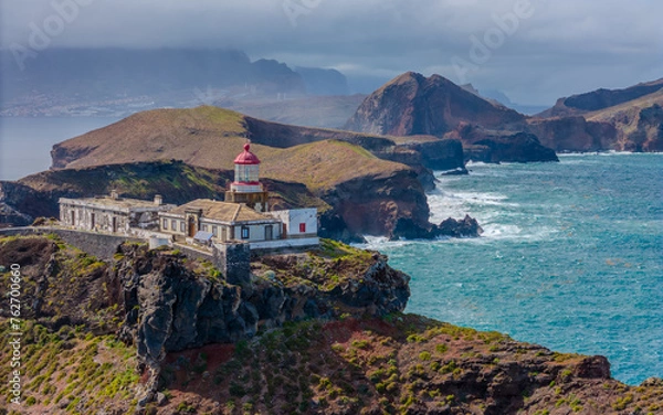 Fototapeta Lighthouse at Sao Lourenco peninsula on Madeira from an aerial view.
Drone photos of Farol da Ponta de São Lourenço with ocean waves and clouds.