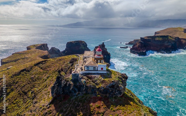 Fototapeta Lighthouse at Sao Lourenco peninsula on Madeira from an aerial view.
Drone photos of Farol da Ponta de São Lourenço with ocean waves and clouds.