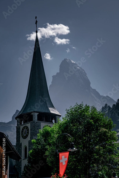 Fototapeta Steeple of St Mauritius parish church in Zermatt with Matterhorn in background in Switzerland.