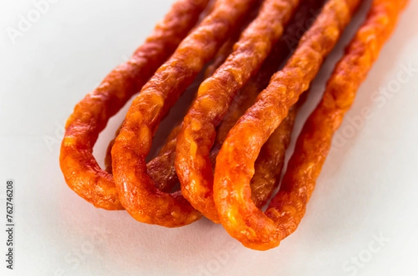 Obraz Many thin sausages on a white background