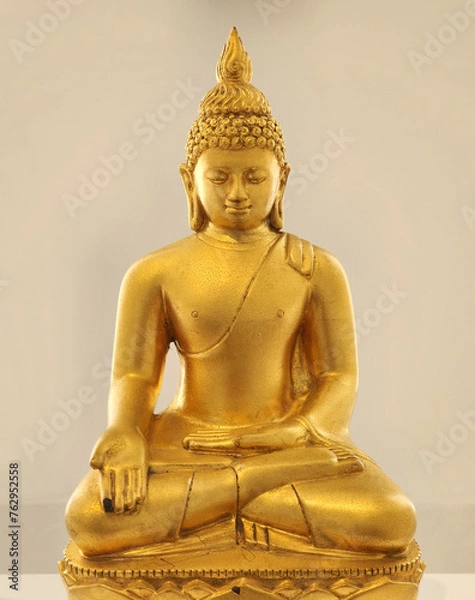 Obraz Golden Buddha statue in a sitting position cream backdrop