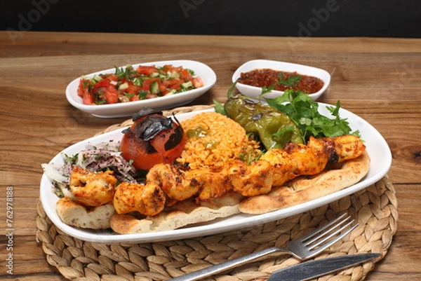 Fototapeta grilled chicken skewers with bulgur pilaf, roasted tomatoes and peppers