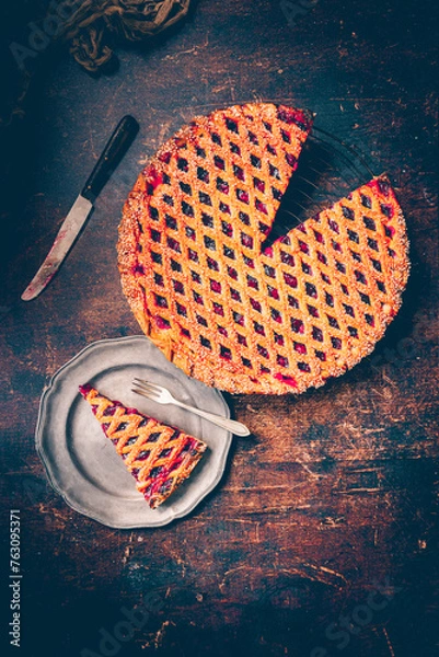 Obraz Kersenvlaai. Dutch cherry pie. Cherry pie with dough lattice from Limburg, Netherlands. Handbaked open cherry pie, delicious sweet dessert served on a wooden table.