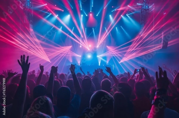 Fototapeta Concertgoers enjoying laser display