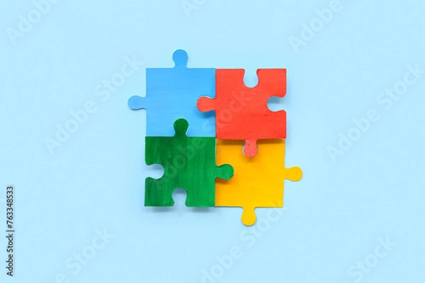 Fototapeta Color puzzle on blue background. Concept of autistic disorder