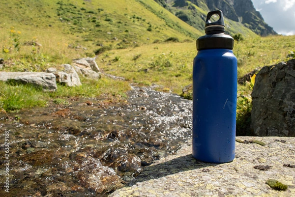 Obraz  Eco-Friendly Water Bottle by a Mountain Stream