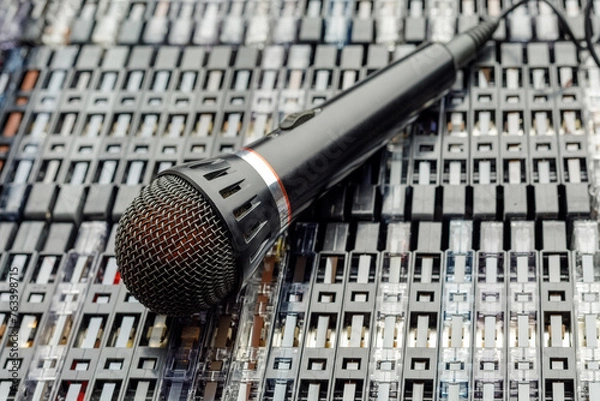 Fototapeta Tabletop view - stacked audio cassettes and microphone on them