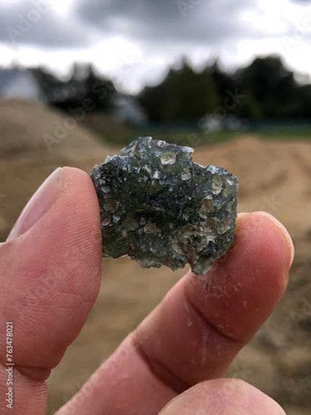 Obraz Holding up a freshly mined moldavite gem