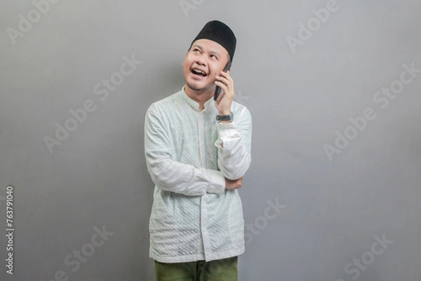 Obraz Portrait of an Asian Muslim man calling with family or friend