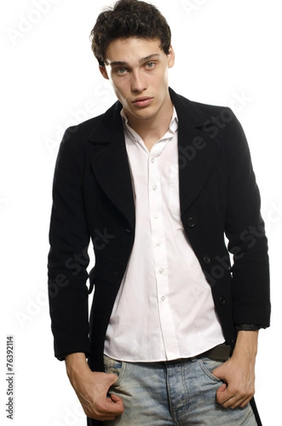 Fototapeta Portrait of a beautiful young man dressed in a black long coat a