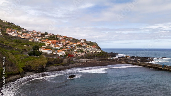 Fototapeta Aerial view of Seixal, a little village by the ocean with waves and surrounded with incredible mountains on the island of Madeira, Portugal.