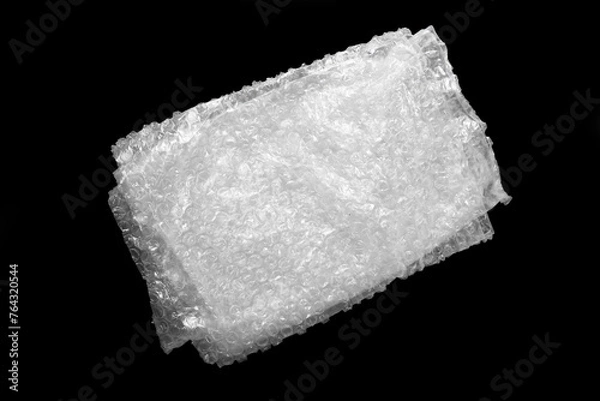 Fototapeta Folded transparent bubble wrap on black background, top view