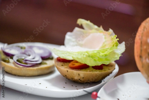 Fototapeta Preparation steps of homemade hamburger with fresh vegetables, spices, cheese and meat