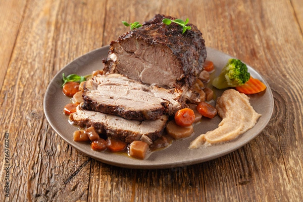 Obraz Whole roasted pork neck, stewed in wine with vegetables.