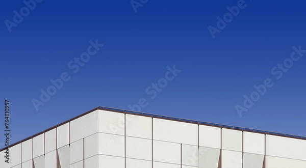 Obraz Top edge of a modern building and blue sky