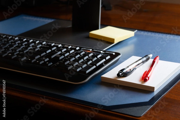 Fototapeta Computer on Note Pads on Desk