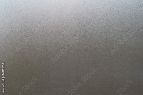Fototapeta Water drops on fogged glass with a gray brightness gradient. Background