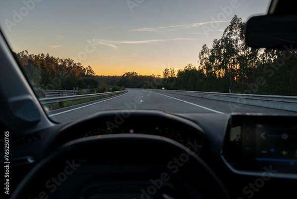 Fototapeta View from inside the car to highway with sunset in the background. Night fall view from Driver POV to the road landscape.