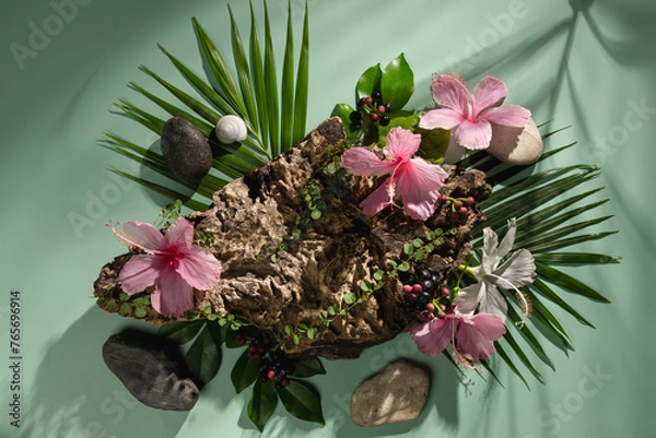 Fototapeta A wooden stand decorated with flowers, leaves and stones, used to display products and advertise.