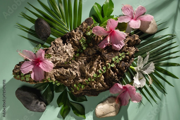 Fototapeta A wooden stand decorated with flowers, leaves and stones, used to display products and advertise.