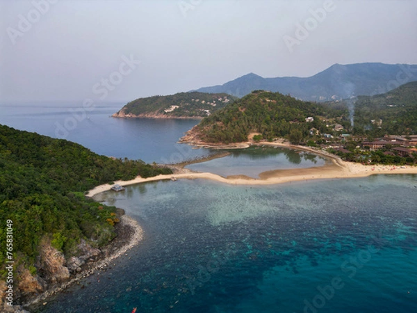 Obraz Aerial drone view small Koh Ma island, Ko Phangan Thailand. Exotic coast panoramic landscape, Mae Haad beach, summer day. Sandy path between corals. Vivid seascape, mountain coconut palms from above.