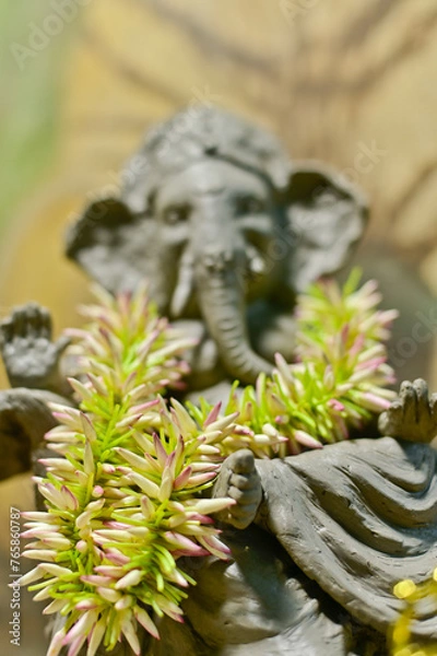 Obraz Garland of flower buds of Jasmine around the neck of a deity as a part of worship in India.