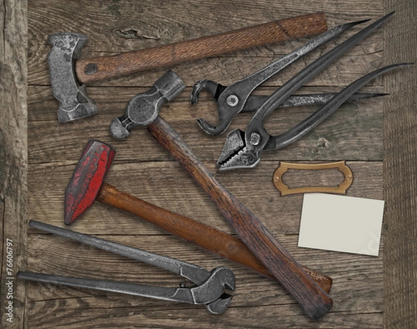 Obraz blacksmith tools and business card over bench