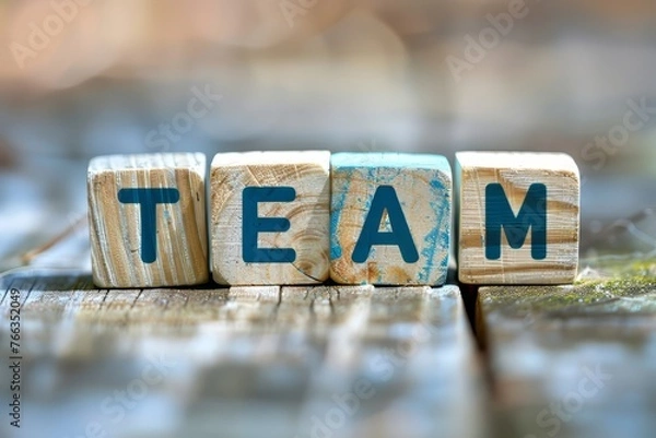 Fototapeta Wooden cubes with the text "TEAM" in the style of a business team concept