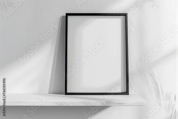 Fototapeta Vertical 8x10 Black frame mockup. Black frame poster on a white wooden shelf and white wall. 3D illustrations
