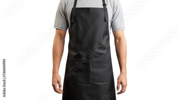 Fototapeta A man confidently wears a black apron in a modern kitchen setting