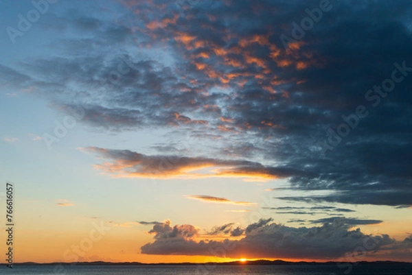 Obraz Orange sunset. Big, dark clouds.