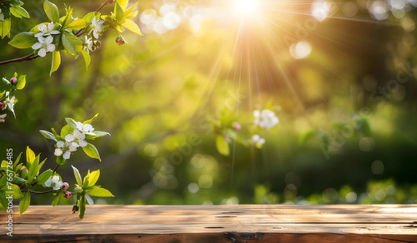 Fototapeta Slightly blurred out of focus wallpaper of tree branches and garden under sunlight from point of view of empty wooden table.