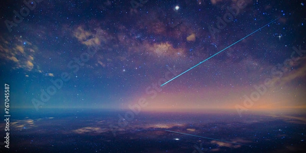 Fototapeta Beautiful night filled with many stars twinkling in the night sky. Stardust in deep universe.A meteor is falling from the sky. Shooting star and nebula in starry night sky.