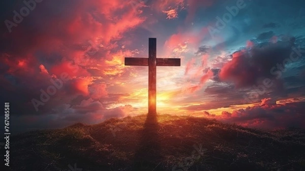 Fototapeta A Holy cross silhouetted against a dramatic sunset, symbolizing the death and resurrection of Jesus Christ 