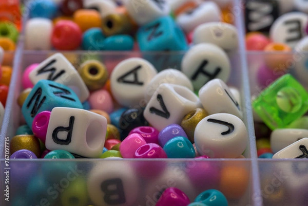 Fototapeta Colorful round rings and dice with letters to make jewelry bracelets for children