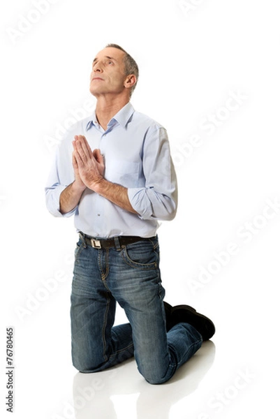 Obraz Man kneeling and praying to God