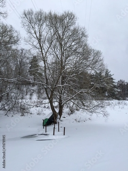 Obraz A lonely boat on a river in winter