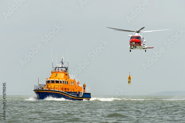 Fototapeta Pomarańczowa łódź ratownicza z helikopterem ratunkowym