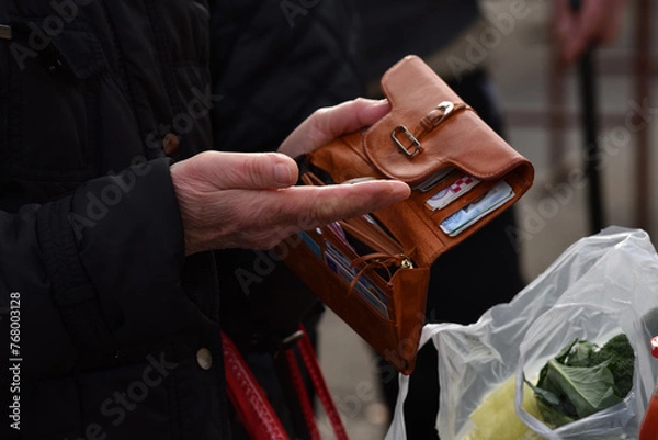 Fototapeta Zagreb, Croatia : 01, 05, 2024 : Close-up of paying  with euros at the vegetable market in Zagreb.