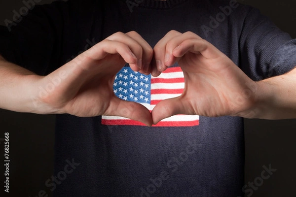 Obraz man with american flag on shirt showing heart of his hands