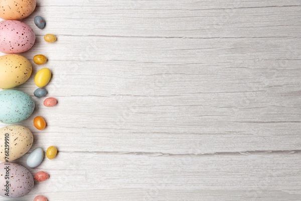 Fototapeta easter eggs on left of frame on wooden surface